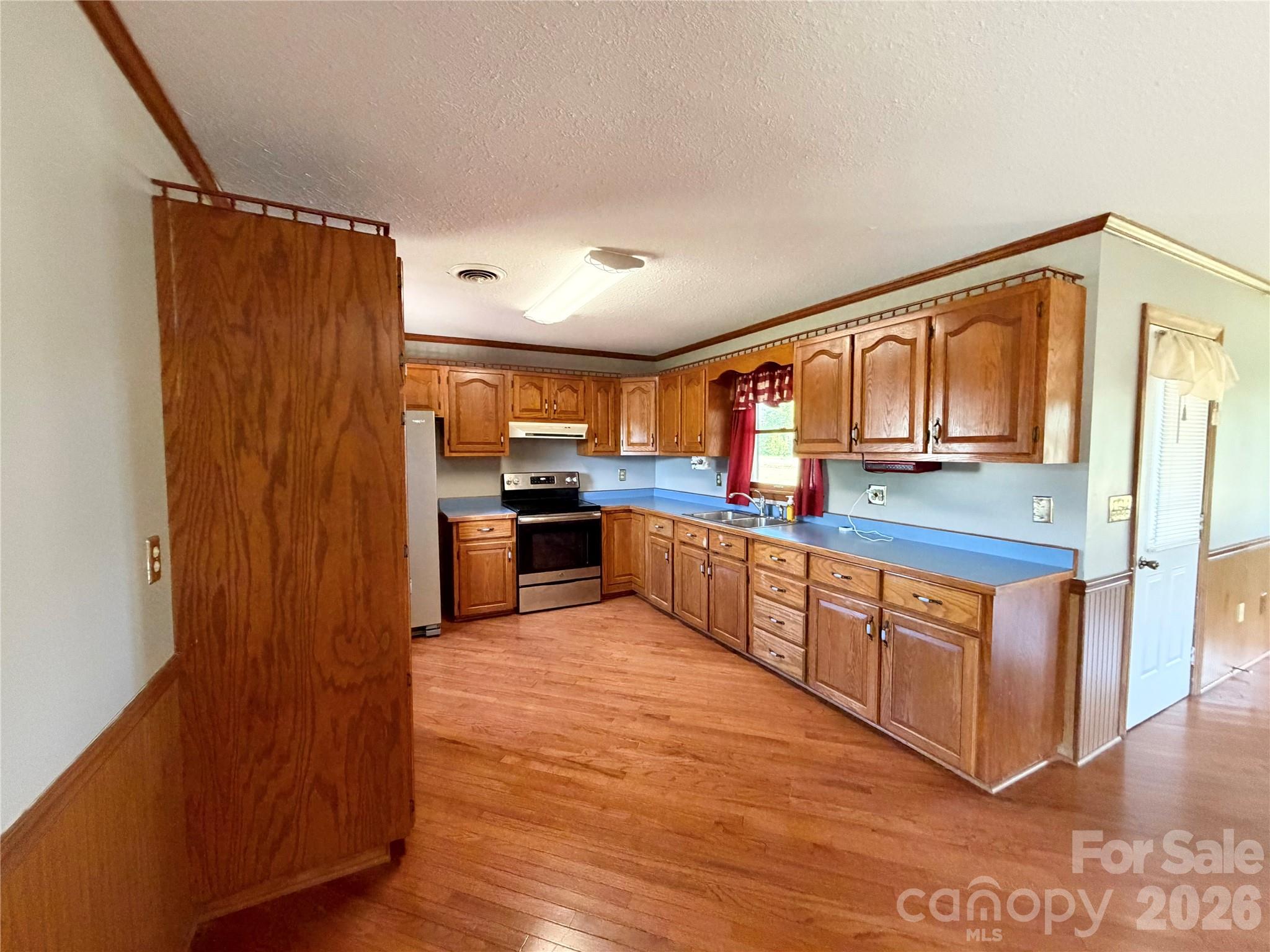 372 Ferry Road Forest City, NC 28043 - Photo 9 of 36 a large kitchen with stainless steel appliances granite countertop a refrigerator and wooden cabinets