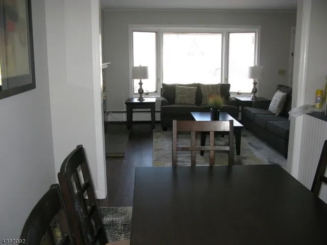 a view of a dining room with furniture and window