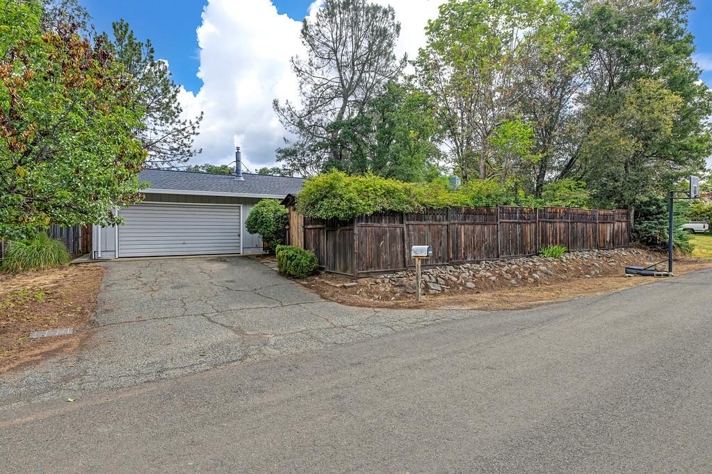 6689 Rhodes Avenue Placerville, CA 95667 - Photo 2 of 60 a view of a backyard with large tree and wooden fence