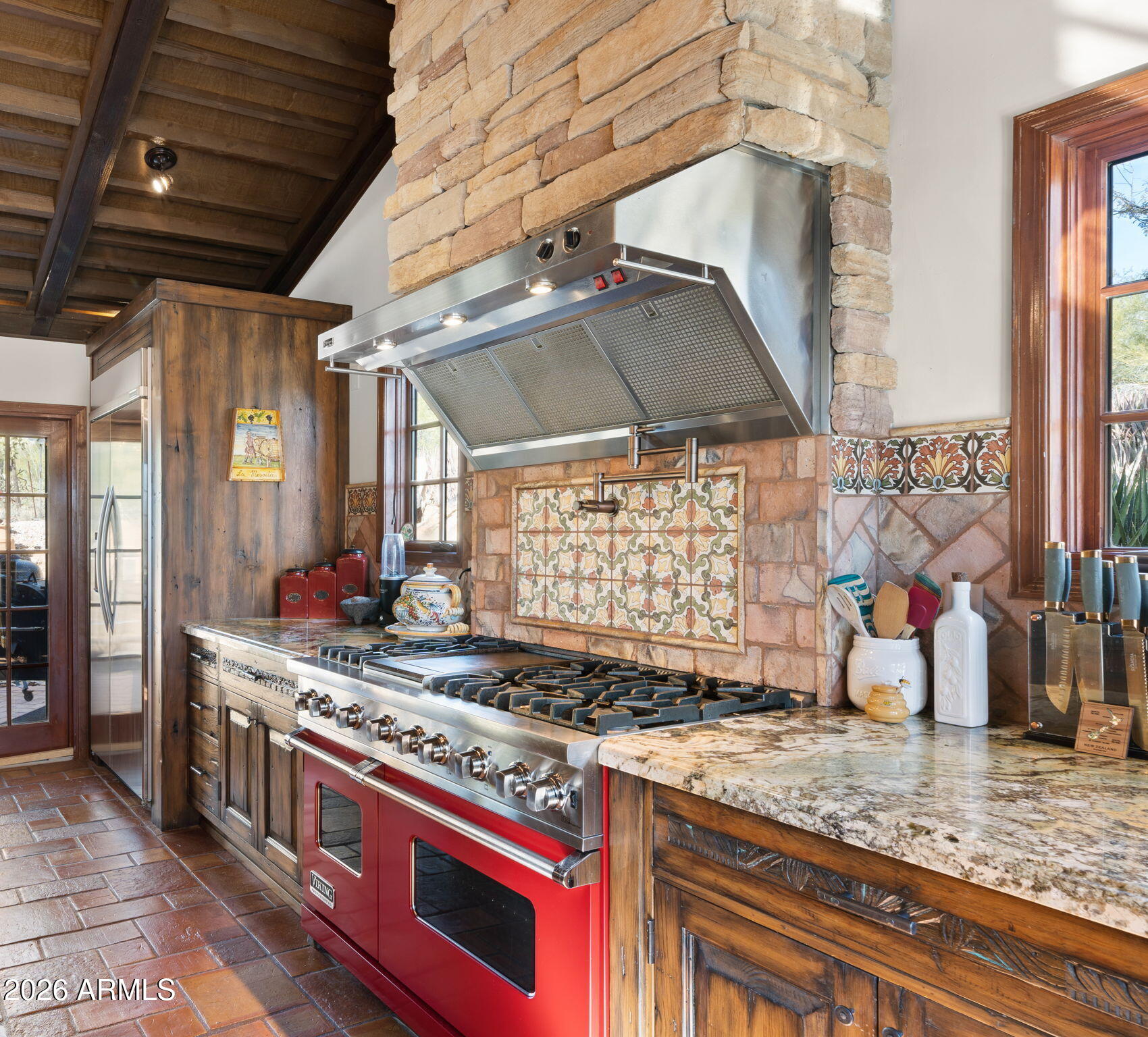35035 Whileaway Road Carefree, AZ 85377 - Photo 26 of 64 a kitchen with stainless steel appliances granite countertop a sink a stove and a wooden floor