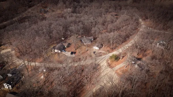 a view of a livingroom with wooden floor and a window