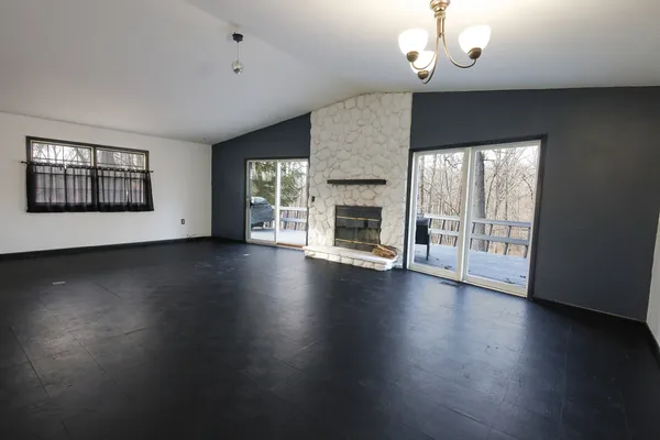 a living room with a fireplace and a window