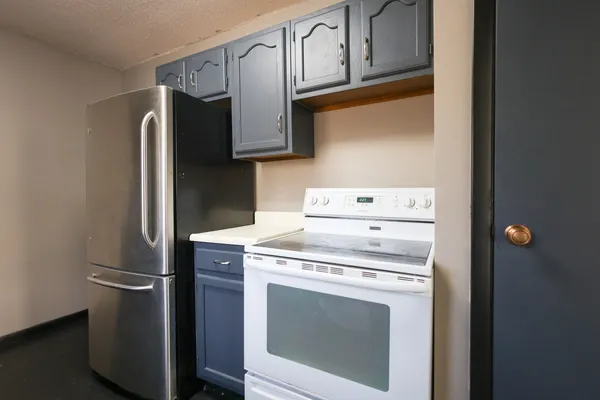 a kitchen with stainless steel appliances granite countertop a sink a stove and microwave