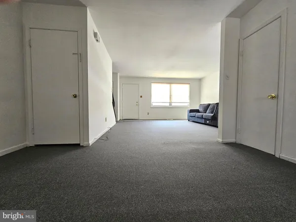 a view of a livingroom and a empty room