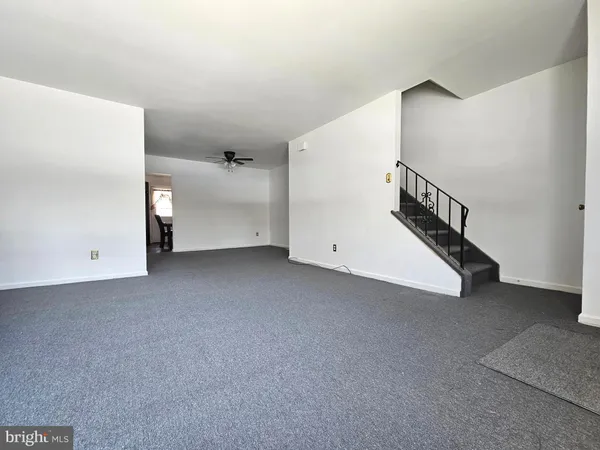 a view of an empty room with stairs
