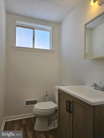 a bathroom with a sink a toilet and a mirror