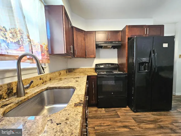a kitchen with a refrigerator sink and cabinets