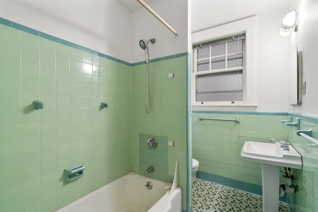 135 Freeman Street, Unit 1A Brookline, MA 02446 - Photo 14 of 22 a bathroom with a sink a toilet and shower