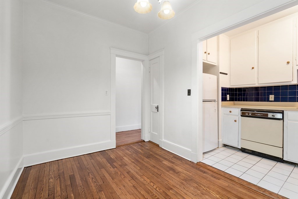 135 Freeman Street, Unit 1A Brookline, MA 02446 - Photo 5 of 22 a view of a kitchen with wooden floor