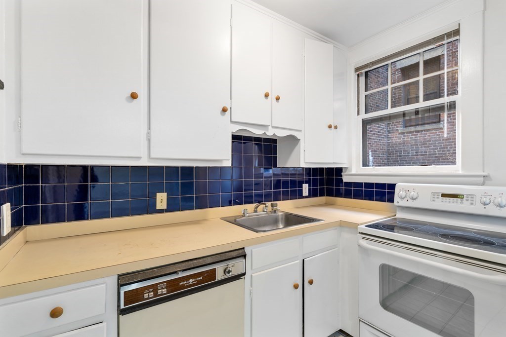 135 Freeman Street, Unit 1A Brookline, MA 02446 - Photo 6 of 22 a kitchen with a sink and a stove top oven