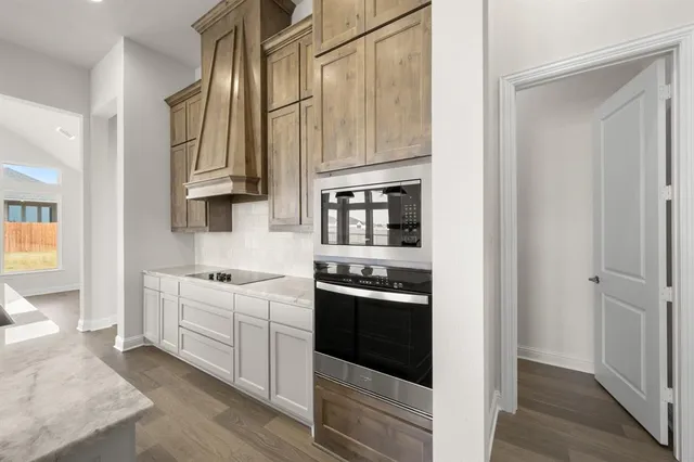 a kitchen with stainless steel appliances granite countertop a stove and a refrigerator