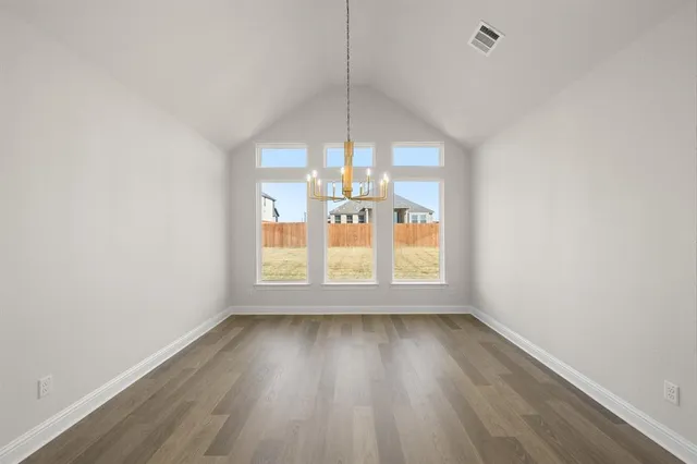 a view of a room with wooden floor fan and window