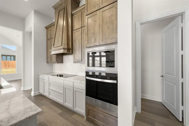 a kitchen with stainless steel appliances granite countertop a stove and a refrigerator