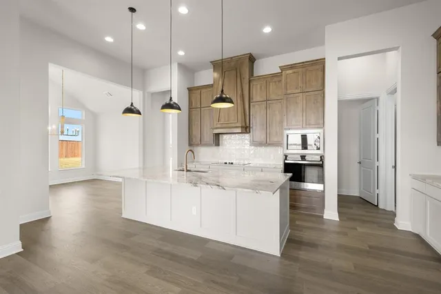 a kitchen with a sink appliances and cabinets