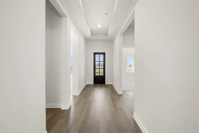 a view of a hallway with wooden floor