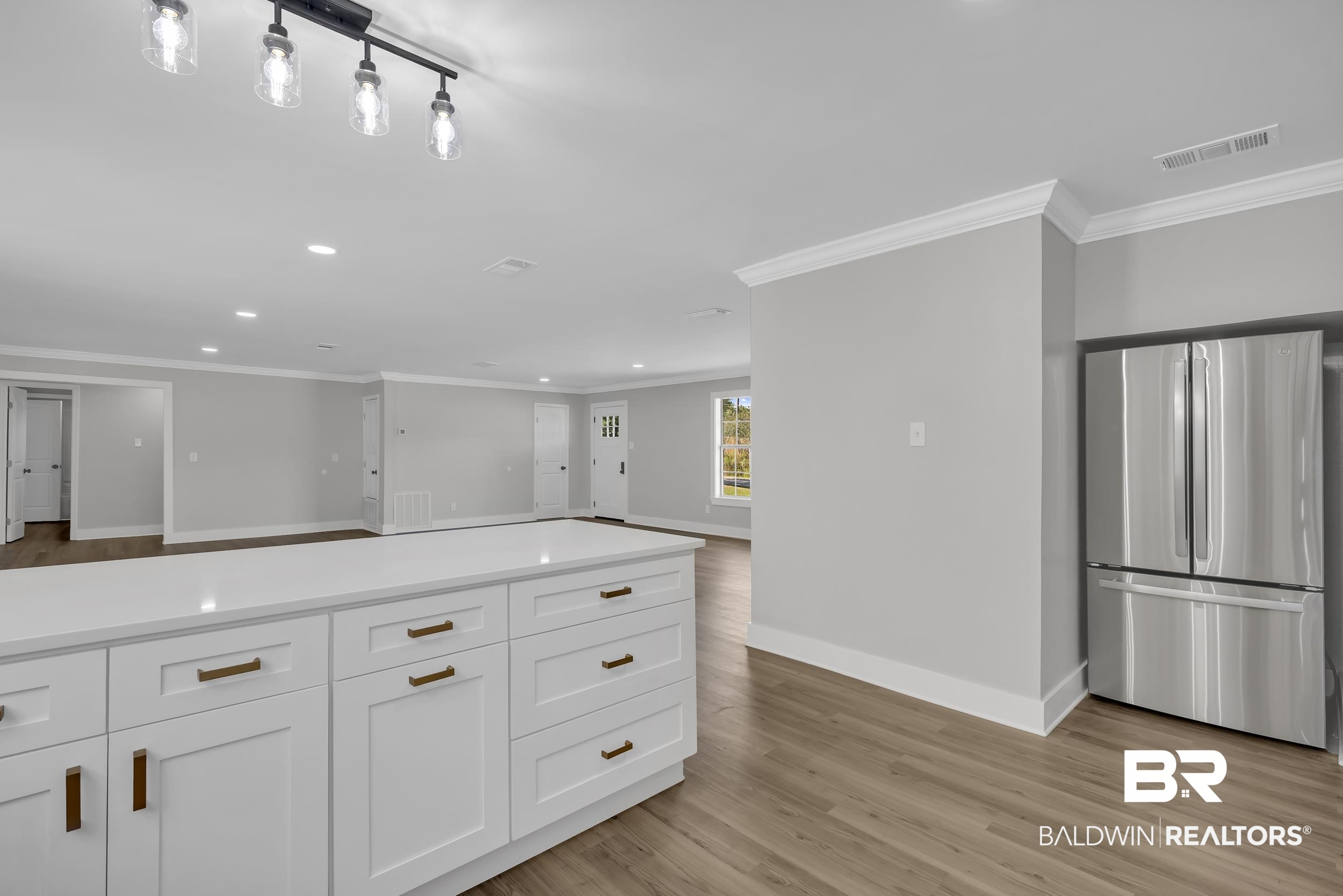 8351 Theodore Dawes Road Theodore, AL 36582 - Photo 46 of 46 Kitchen featuring freestanding refrigerator, recessed lighting, ornamental molding, light wood finished floors, and open floor plan