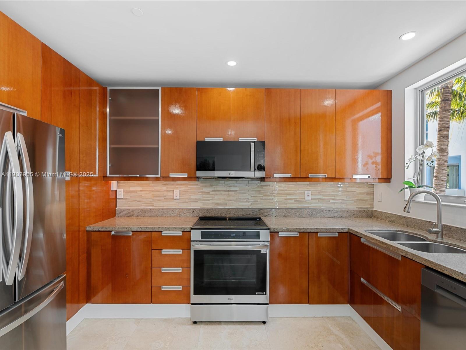 155 North Shore Drive, Unit 1553 Miami Beach, FL 33141 - Photo 13 of 48 a kitchen with stainless steel appliances granite countertop a stove a sink and a refrigerator