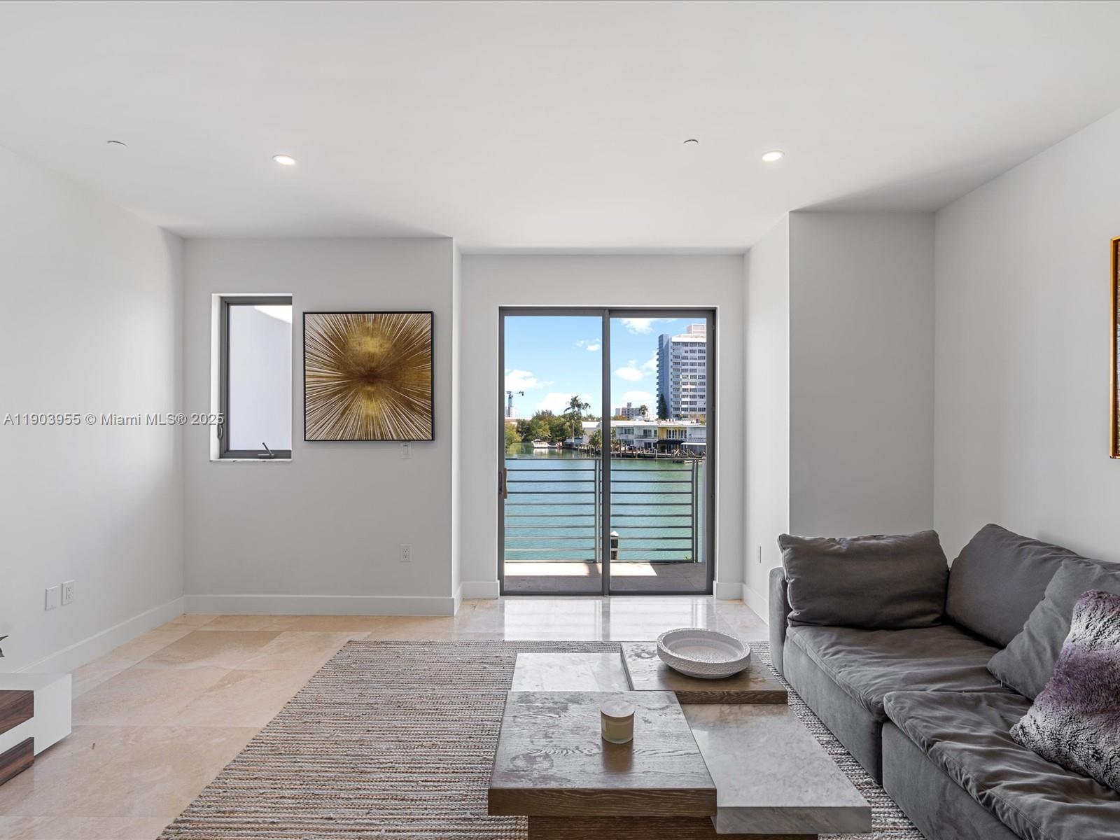 155 North Shore Drive, Unit 1553 Miami Beach, FL 33141 - Photo 20 of 48 a living room with furniture and a large window