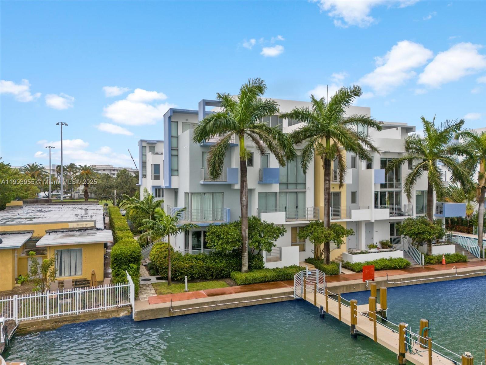 155 North Shore Drive, Unit 1553 Miami Beach, FL 33141 - Photo 2 of 48 a house with palm tree in front of it