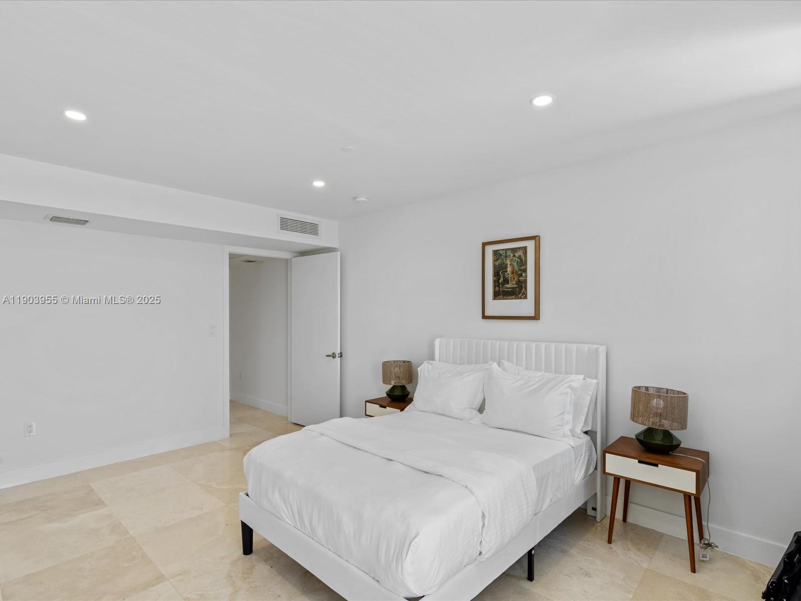 155 North Shore Drive, Unit 1553 Miami Beach, FL 33141 - Photo 23 of 48 a bedroom with a bed and a chair