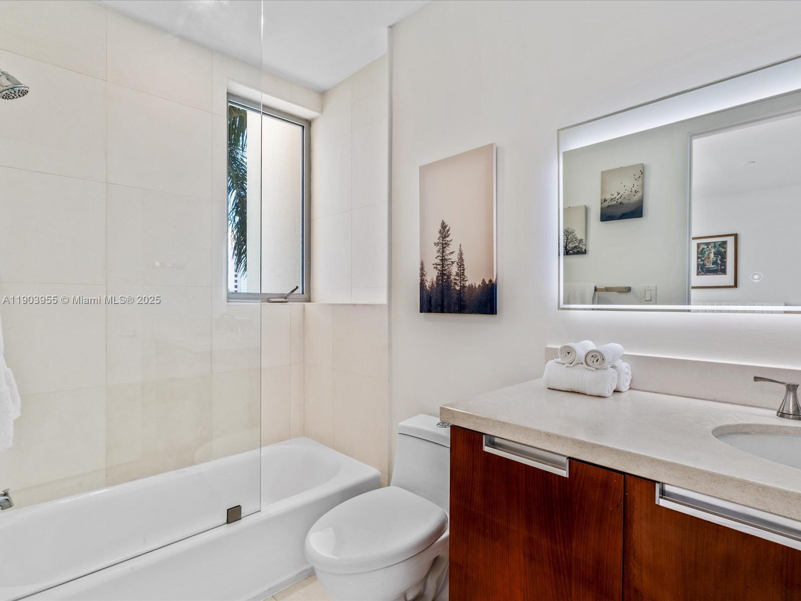 155 North Shore Drive, Unit 1553 Miami Beach, FL 33141 - Photo 25 of 48 a bathroom with a sink a toilet and shower