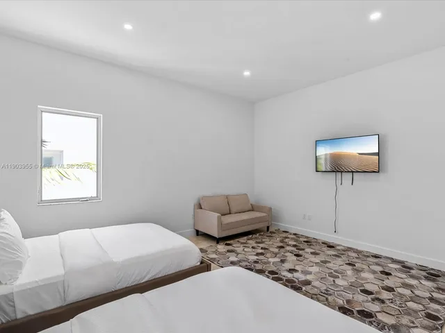 a bedroom with furniture and a window