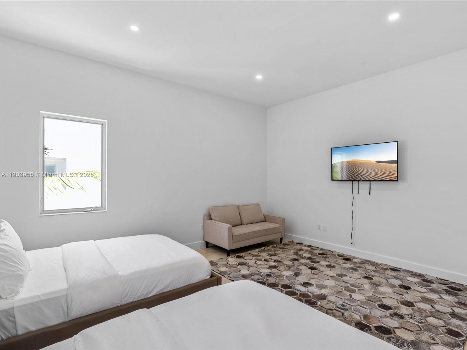 155 North Shore Drive, Unit 1553 Miami Beach, FL 33141 - Photo 30 of 48 a bedroom with furniture and a window