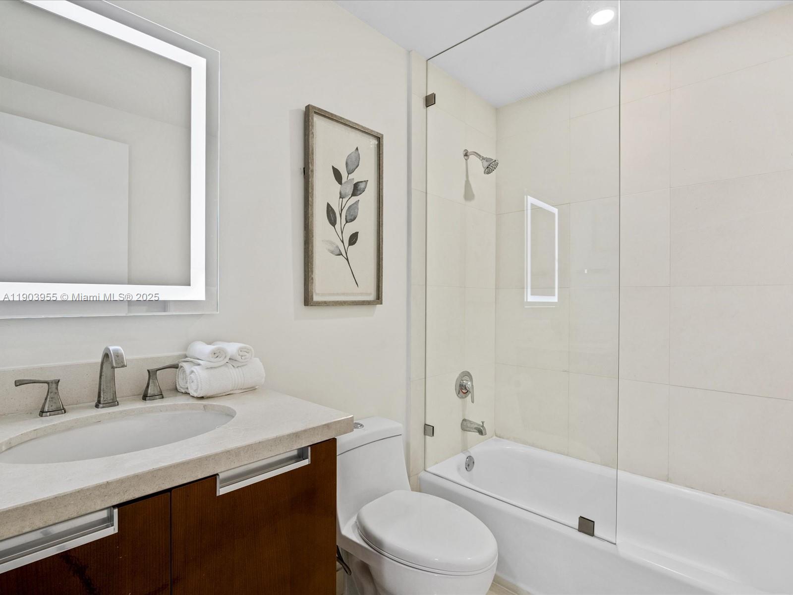 155 North Shore Drive, Unit 1553 Miami Beach, FL 33141 - Photo 31 of 48 a bathroom with a sink toilet and shower
