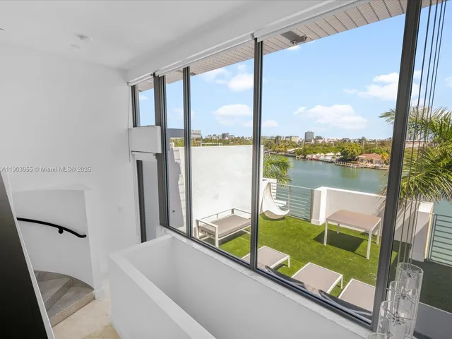 a bathroom with a large window and a bath tub