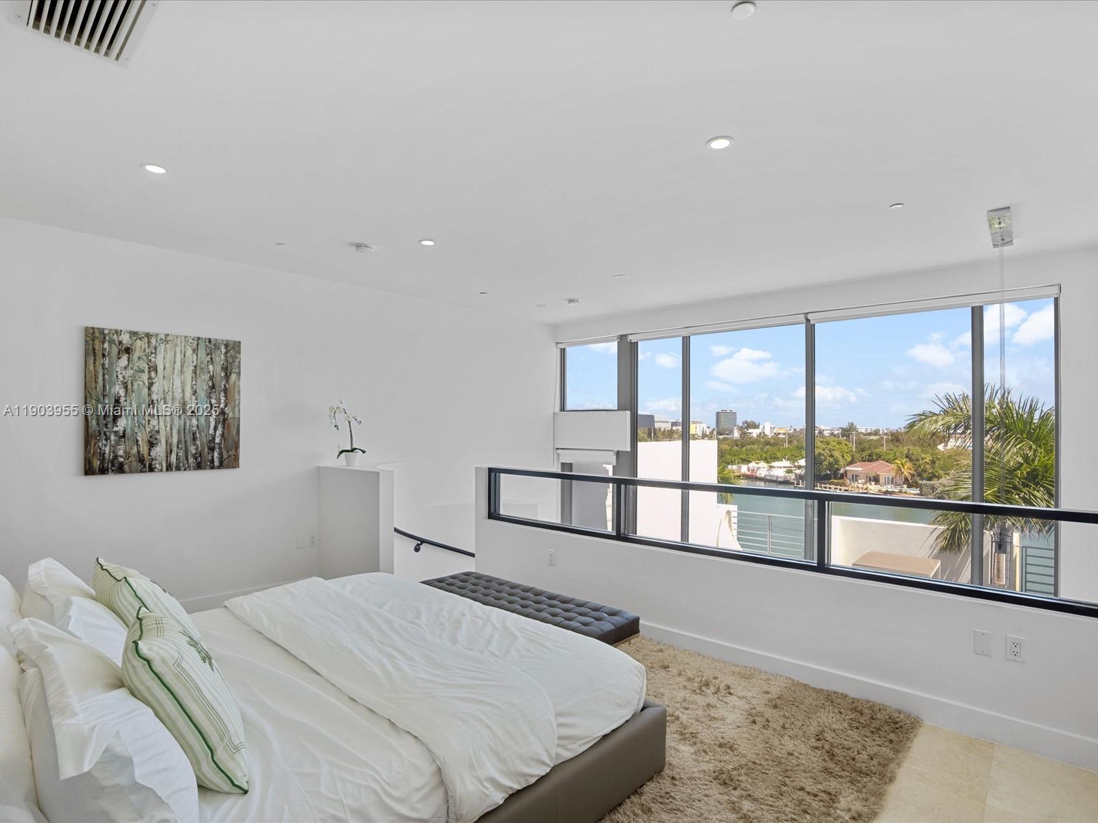 155 North Shore Drive, Unit 1553 Miami Beach, FL 33141 - Photo 36 of 48 a bedroom with a large bed and a large window