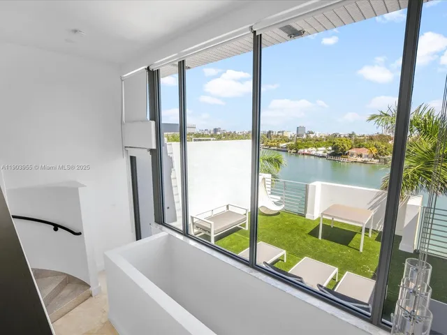 a bathroom with a large tub and shower view