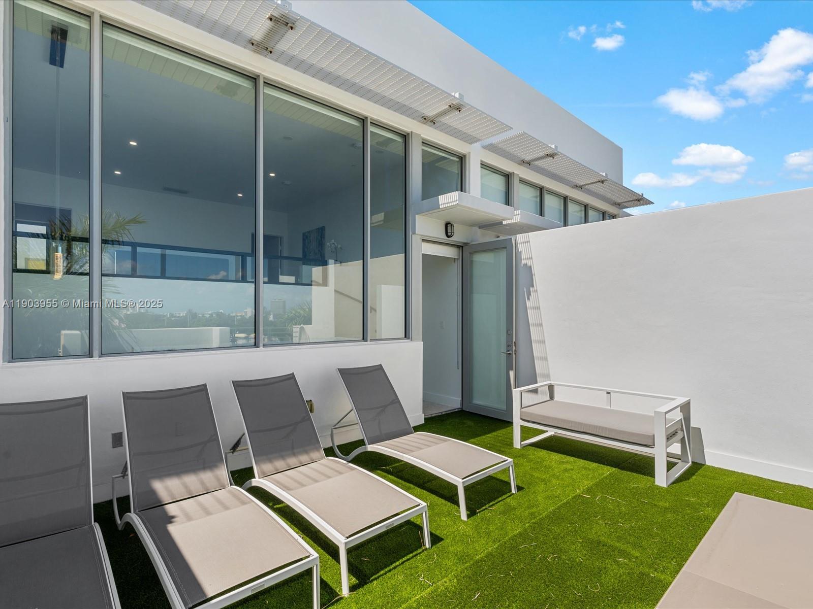 155 North Shore Drive, Unit 1553 Miami Beach, FL 33141 - Photo 41 of 48 a balcony with table and chairs