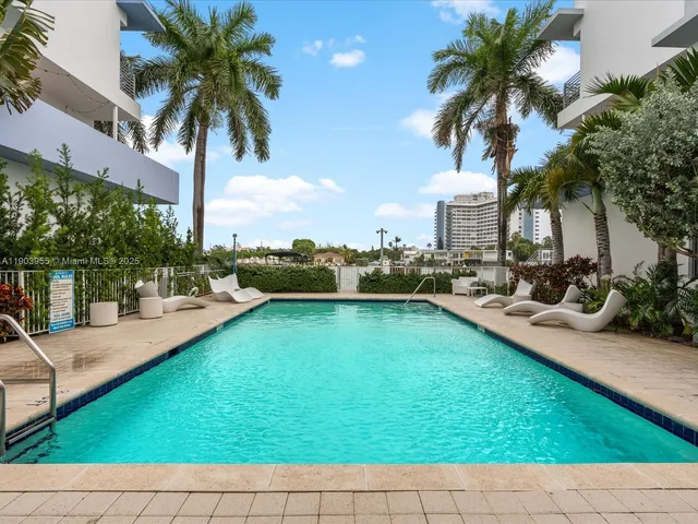 a view of a swimming pool with a patio and a yard