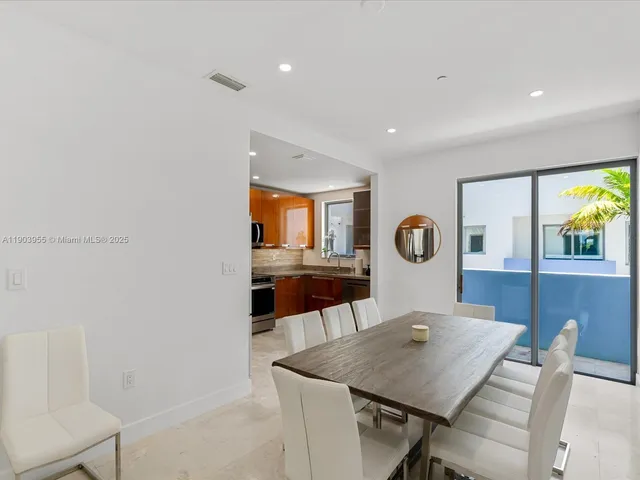a view of a dining room with furniture and window