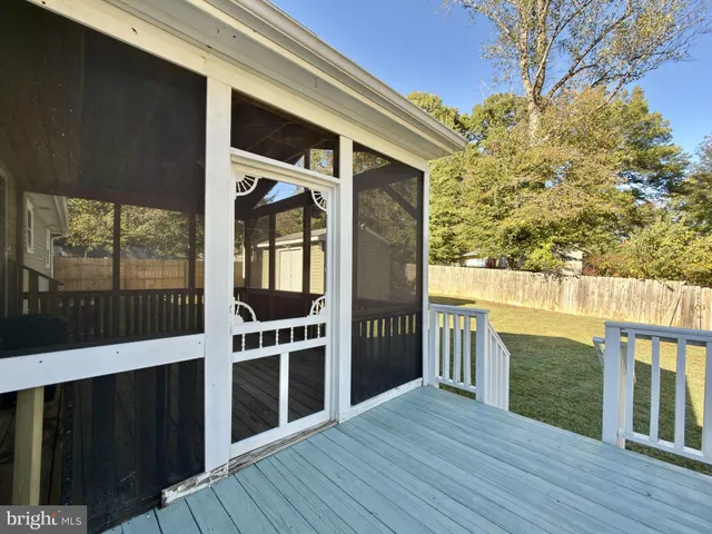 a view of front door deck of house and wooden floor
