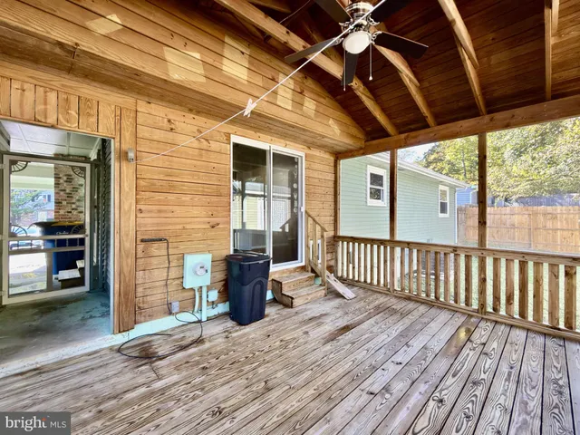a view of a porch with wooden floor and iron stairs
