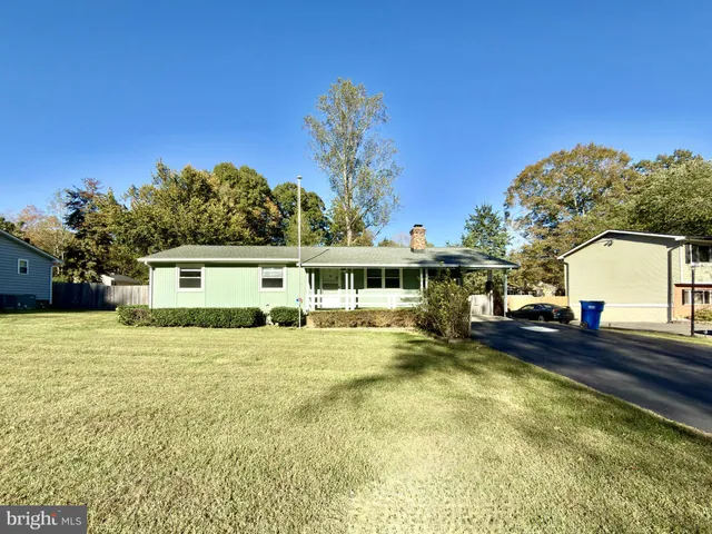 a view of a house with pool and a yard