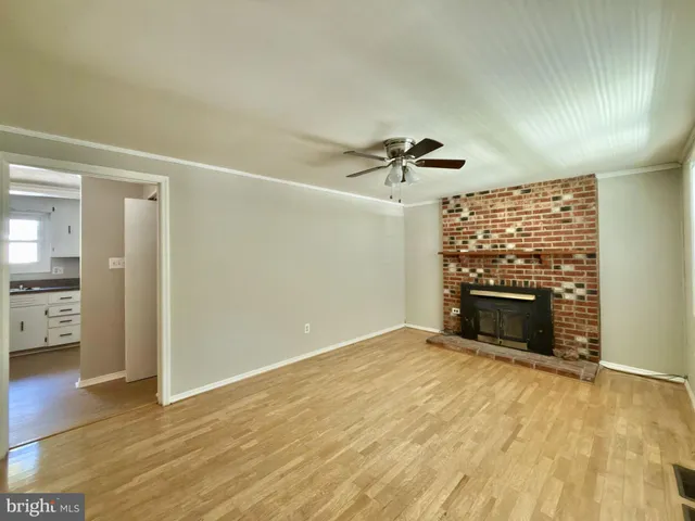 wooden floor in an empty room with a fireplace