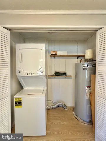 a utility room with closet dryer and washer