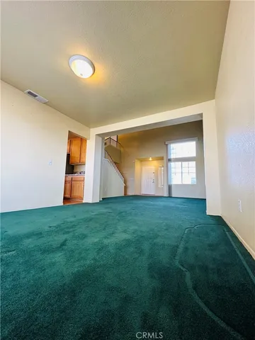 a view of a big room with windows and fireplace