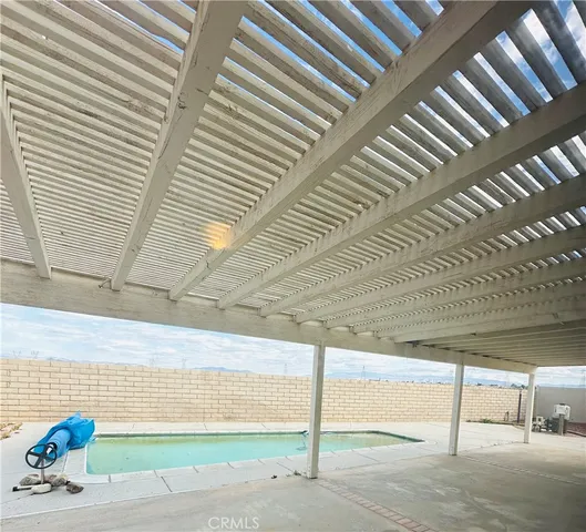 a view of a swimming pool with a yard
