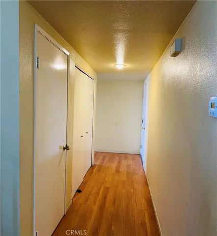a view of a hallway with wooden floor