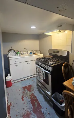 a kitchen with stainless steel appliances granite countertop a stove and a sink