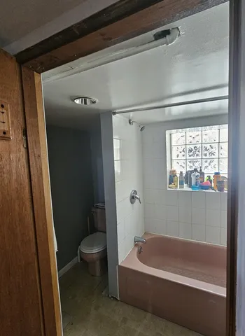 a bath tub sitting next to a toilet