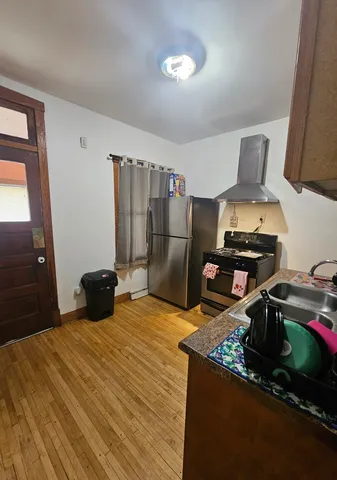 a kitchen with a stove and a refrigerator