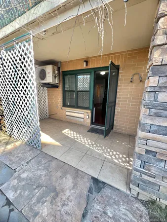 a view of a brick wall with an outdoor space