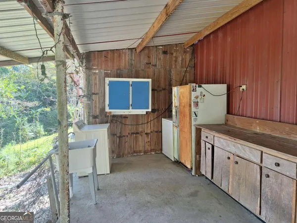 a view of backyard with green space and seating