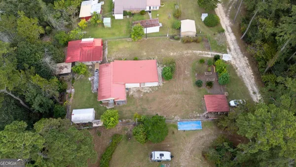 an aerial view of a pool yard and outdoor seating