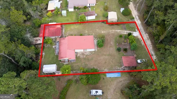 an aerial view of residential houses with outdoor space and swimming pool