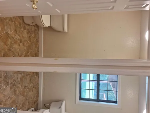 a view of a closet area with wooden floor